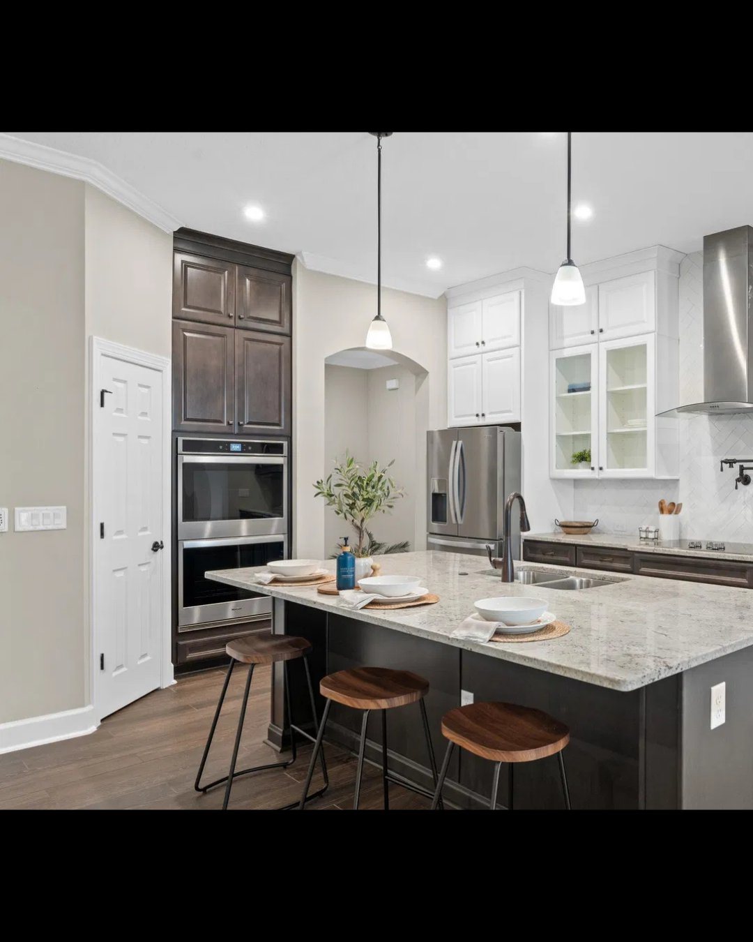 Luxury kitchen with dark island and quartz countertops in a St. Augustine home